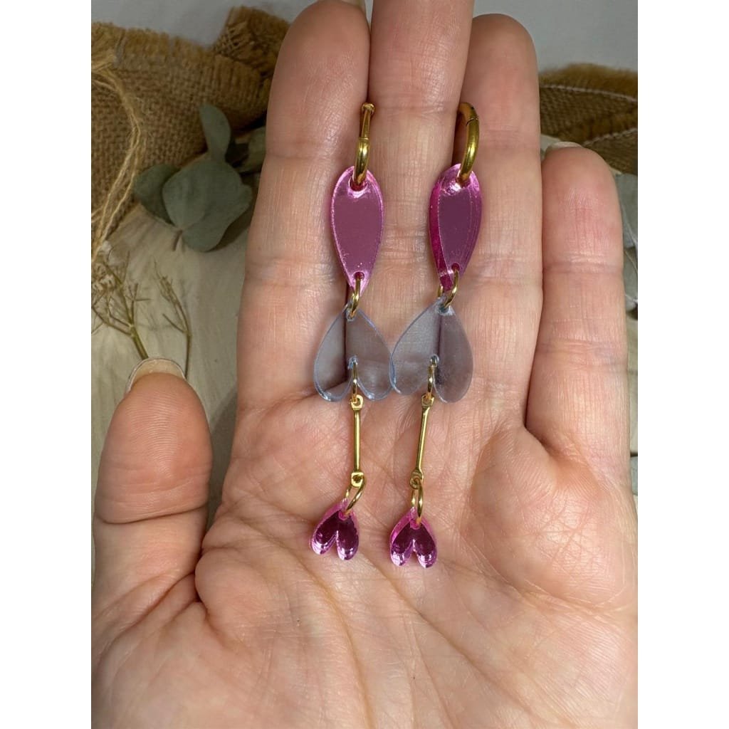 Los Pendientes Lágrimas de Corazón son una pieza delicada y original que combina diseño, movimiento y elegancia. Su forma alargada y ligera estiliza el rostro, mientras que la mezcla de corazones aporta un aire romántico y actual. Un diseño pensado para acompañarte tanto en el día a día como en momentos especiales.
