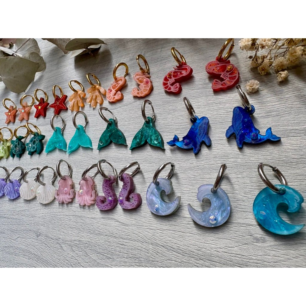 Descubre TESOROS DEL MAR, la colección más divertida y personalizable del verano. Pendientes inspirados en el océano para crear combinaciones únicas, llenas de color, brillo y personalidad. Elige tus figuras favoritas, mezcla colores y crea un diseño totalmente a tu gusto. Características: Diseño exclusivo de JudithconAlma Modelos disponibles: concha, coral, estrella de mar, ballena, tortuga, ola, cola de ballena, barco de papel, tentáculos, sepia y gambitas Tamaño aproximado: 1,7 x 1,7 cm Posibilidad de elegir pendientes iguales o diferentes Personalizables en color y combinación Opción con aro o sin aro Aro disponible en color dorado o plateado Aros de acero inoxidable aptos para alergias Ligeros y muy cómodos de llevar Perfectos para looks veraniegos, coloridos y desenfadados Ideales para playa, vacaciones, festivales y verano Cada combinación es única y hecha con mucho mimo