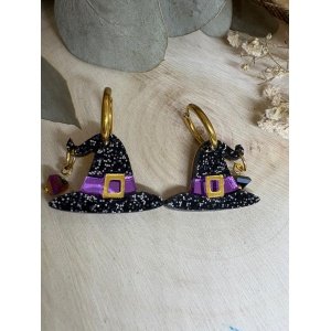 ¡Un toque de magia en tu look! Luce un estilo chic y misterioso este Halloween con los nuevos pendientes Gorrito de Bruja. Diseñados y elaborados de forma 100% exclusiva para nuestra colección Halloween 2026, son la combinación perfecta de brillo, color y elegancia. Características Destacadas Diseño: Exclusivo de Judith con Alma, Colección Halloween 2026. Modelos disponibles: Negro Glitter, Morado y Verde. Material principal: Metacrilatos de importación premium (con efectos de purpurina, opacos y espejo). Corte: Láser de alta precisión para acabados limpios y perfectos. Adorno: Elegante piedra de cristal facetada colgante. Cierre: Aros de 1,5 cm de acero inoxidable antialérgico. Medidas del colgante: 2 cm (alto) x 2,5 cm (ancho) - sin contar el aro.